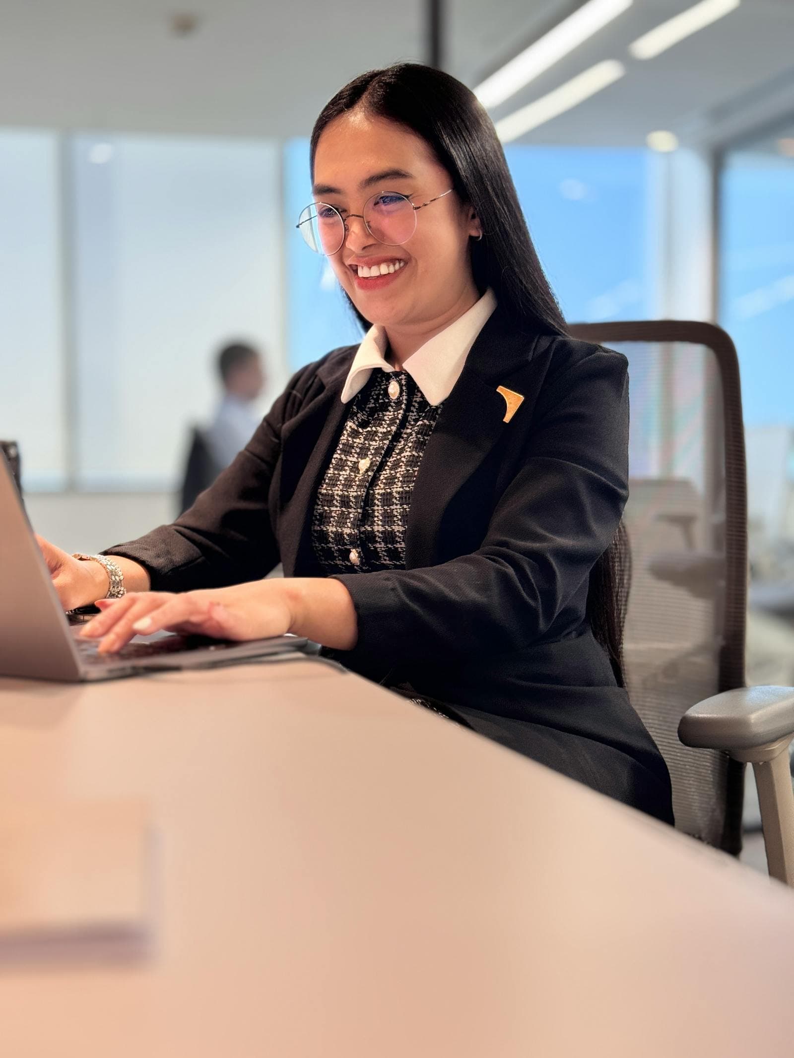 Auction manager working from a laptop at a desk