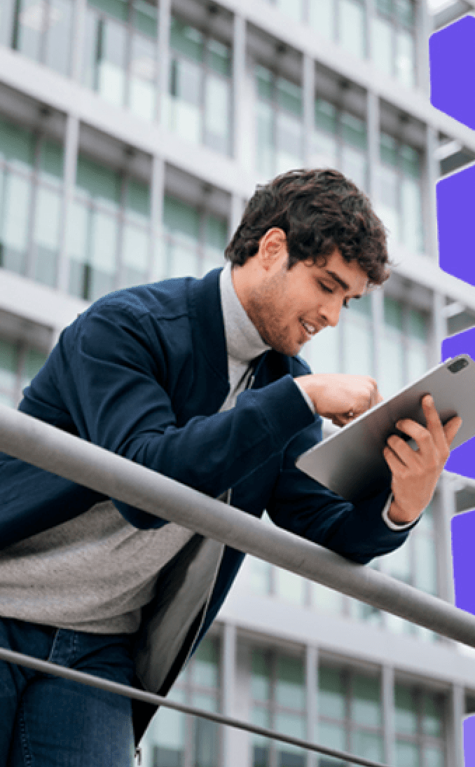 Person using a tablet outside a modern building